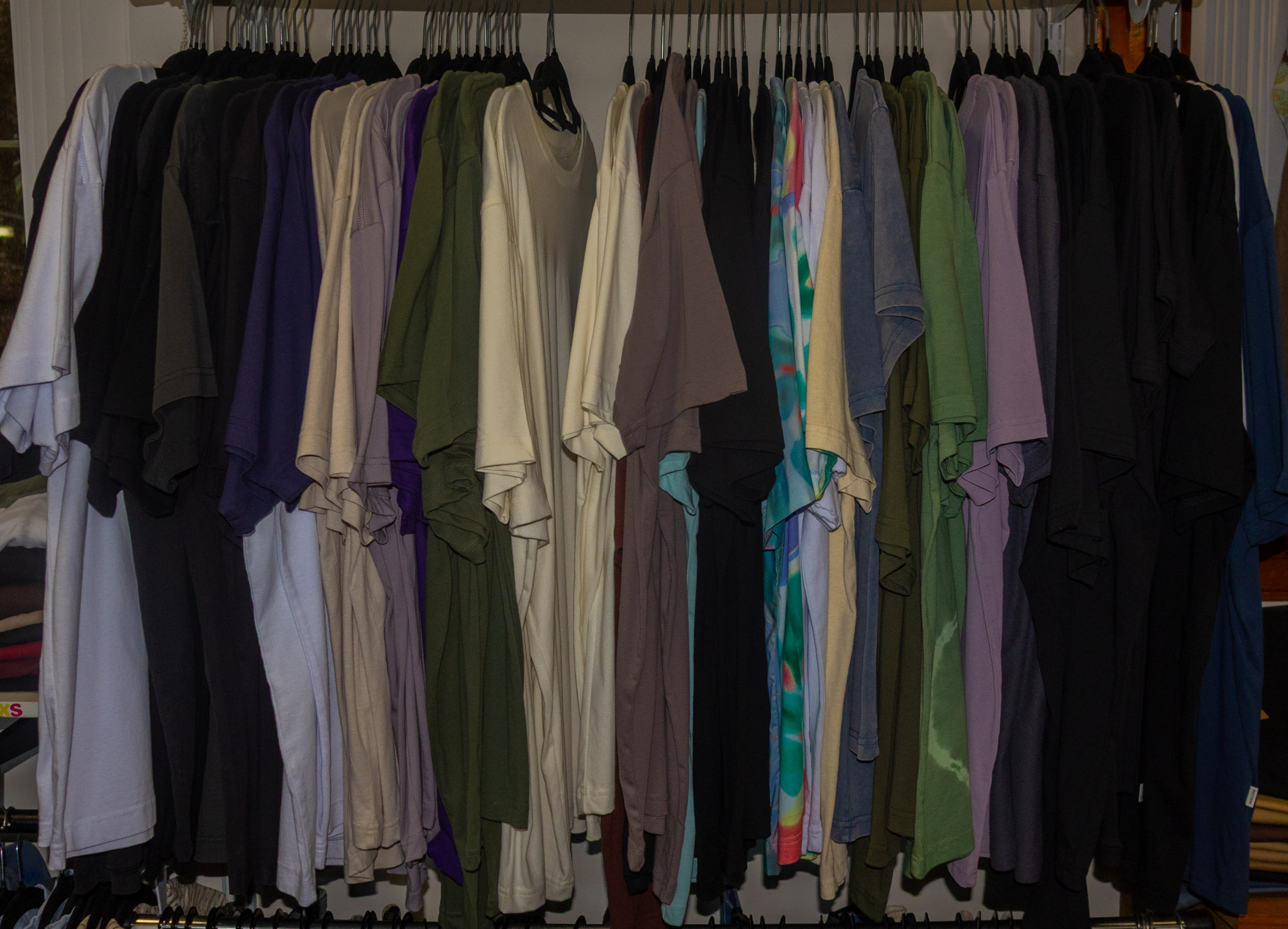 Rail of clothes hanging in RJ's shopfront.