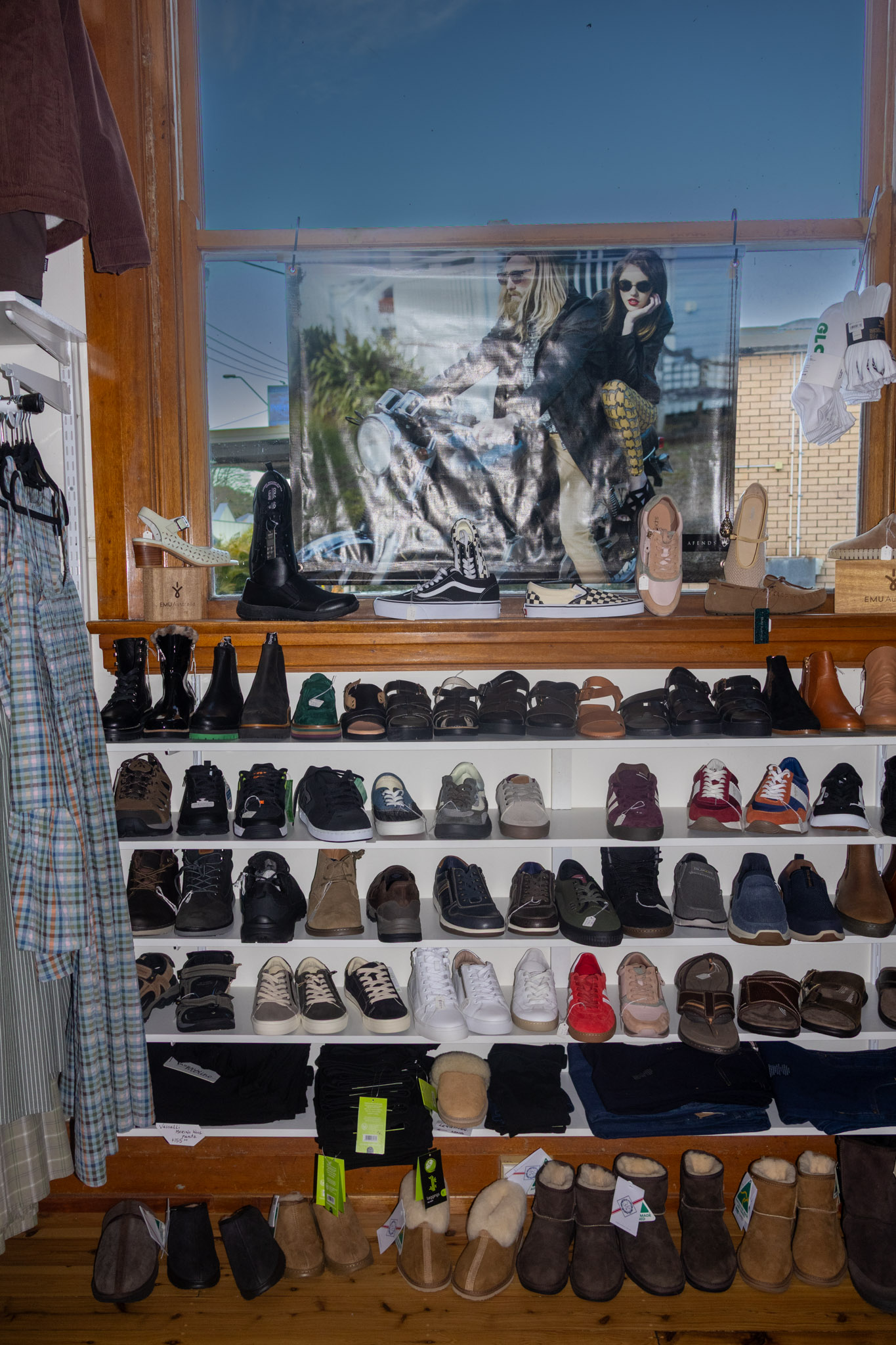 Shelves of sneakers and shoes in store.